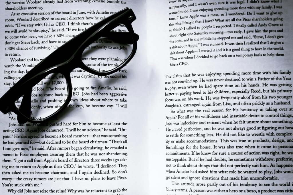 a pair of glasses on pages of text, interior formatting